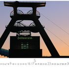 Text: "Zollverein", "Essen, Zeche Zollverein", Monatskalender. Im Vordergrund ein Förderturm bei Sonnenuntergang.