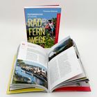 Buchumschlag: "Österreichs schönste Radfernwege". Aufgeschlagenes Buch mit Bildern und Text über Radwege.
