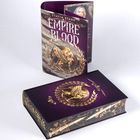 Buchcover und -rücken mit Text "Empire of Blood", Bild eines goldenen Adlers, golden verzierte Details auf lila Hintergrund.