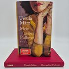 Buchcover mit Text "Ursula März, Mein gelber Pullover". Illustration zeigt eine Frau mit rotem Lippenstift in gelbem Pullover.