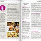 Lebensfreude geht durch den Magen. Leckere Tapas. Bild zeigt mehrere Teller mit Tapas und Gläsern Wein auf einem Tisch.