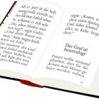 Offenes Buch mit Text: "Der Graf ist beunruhigt". Seiten sind dekorativ bunt verziert.