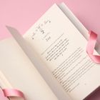1. Kapitel: Zoe. Offenliegendes Buch mit rosa Leseband auf rosa Hintergrund. Verschnörkeltes Design über dem Kapitel.