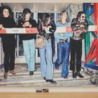 Eine Illustration zeigt fünf Personen, die sich auf eine Schranke lehnen. Auf der Schranke steht "Medic".