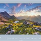 Text: "Mai 2027" über einem Kalender. Landschaft mit Bergen, Wiese, Felsen und Sonnenstrahlen.