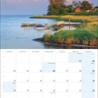 Kalender für Mai 2027, Feiertage wie Christi Himmelfahrt. Foto: Küstenlandschaft mit Steg, Boot und Bäumen bei Sonnenuntergang.