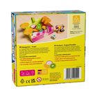 Text: "Obstgarten – Tropic. Im Tropenparadies winkt ein sonniger Sonntagmorgen!"  
Spielbeschreibung mit bunten Holzteilen.