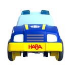 Text: "HABA". Illustration eines blauen Spielzeug-Polizeiautos mit gelben Elementen.