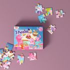 "3 Puzzles" steht groß auf einer Schachtel mit bunten Einhörnern und Tieren. Puzzleteile liegen verstreut.
