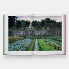 Text: "Kasteel Eve, Baten, Belgium". Bild eines gepflegten Gartens mit Gemüsebeeten, Bäumen und einer alten Mauer.