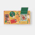 „Let's spread kindness!“, „A gift's extra special when wrapped with care.“, „Who will you surprise with your present?“  
Illustration: Geschenkverpackung, Schere, Lebkuchenmann, Karten.