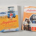 Oben steht: „Was ist dein Geschenk an die Welt? Worin bist du unschlagbar?“ Unten ein festlich beleuchteter Doppeldeckerbus als Café.