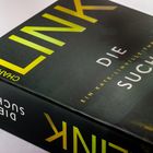 Text: "DIE SUCHE", "EIN KATE-LINVILLE-THRILLER", "CHARLOTTE LINK". 
Cover eines Buches in dunklen Tönen.