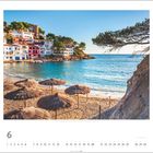 Cala Sa Tuna, Begur, Costa Brava, Spanien. Juni. Strohdächer am Strand, bunte Häuser, blaues Meer und helle Küste.