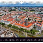 Juni-Kalenderblatt mit Luftaufnahme einer Stadt, rotgedeckte Gebäude, Straßen und Fluss. "Blick über die Altstadt".