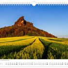 Kalender mit Text: "Die Sonne taucht den Lilienstein in ein ganz besonderes Licht." Monat: Juni. Bild zeigt einen Hügel mit Wald.