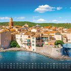 „Saint-Tropez, Provence“ und Monatskalender. Mittelmeerblick auf pastellfarbene Gebäude mit einem Kirchturm.