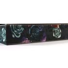 Ein schmaler, rechteckiger Gegenstand mit dunklen, bläulichen und violetten Rosenmotiven an der Seite.