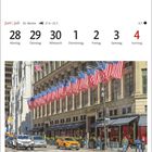 Juni | Juli, 26. Woche, 21.6.–22.7., 28 Montag bis 4 Sonntag. Amerikanische Flaggen und Fahrzeuge auf einer belebten Straße.