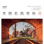 April Kalenderwoche 16, 19. Montag bis 25. Sonntag. 
Ein Gleis führt durch einen gemauerten Torbogen in einen Park.