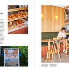 CARACAS BAKERY LOREM IPSUM MIAMI. Innenansicht mit Gebäck, Poster und einer Person, die an einem Laptop arbeitet.