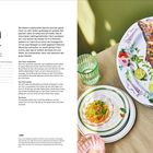 "Pla Pao. Ganzer gegrillter Fisch. Zubereitung für 4-6 Personen. Fisch auf buntem Teller mit Limetten und Kräutern garniert."