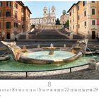 Text: Spanische Treppe. 

Die Szene zeigt eine breite Treppe, einen Brunnen im Vordergrund und umgebende historische Gebäude.