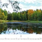 „See in Lappland“ steht links unten. Zahl 8 ist groß. Ein See spiegelt bunte Herbstbäume, umgeben von üppigem Wald.