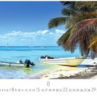 Paradise Beach: Zwei Boote im klaren Wasser, Palmen im Vordergrund, blauer Himmel mit kleinen Wolken, Monat August markiert.
