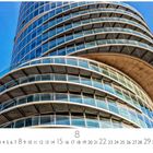 Bochum, Exzenterhaus. Kalenderansicht für den Monat mit hervorgehobener Zahl 8. Glasfassade eines modernen, runden Gebäudes.