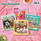 "COZY COLORING", "Girl Moments", "Animals", "Cuties", "Lilo & Stitch", "14+", "Mehr Cozy Moments mit Disney!" 
Vier bunte Malbücher auf rosa Unterlage.