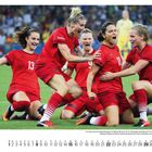 August. Team in roten Trikots jubelt auf Fußballfeld, Kalenderblatt unten.