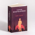 FJODOR DOSTOJEWSKI, DER IDIOT. Lila Buchcover, Silhouette einer Person vor einer stilisierten Stadt.