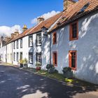 Text "Parliament Square" auf einem blauen Straßenschild an weißen, historischen Häusern mit roten Fenstereinfassungen.