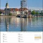 April 2027 Kalenderseite mit Wochenübersicht, Bild von Friedrichshafen mit Mole-Turm und Kirche am Wasser.