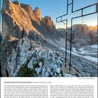 SONNENAUFGANG IM ROSENGARTEN (DOLOMITEN, SÜDTIROL, ITALIEN). Felsige Berglandschaft mit Stahlnadelkreuz im Morgenlicht.