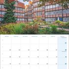 Kalenderseite für August 2027, Hamburg: Fachwerkhäuser umgeben von Bäumen und Garten im Komponistenquartier.