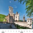 Kalenderblatt April 2027 mit Bild von Schloss Stolzenfels in Koblenz, umgeben von grüner Landschaft und blauem Himmel.