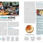 "The Food Scene: Travelling in India is a daily feast – for the eyes, the ears, and particularly for the taste buds." 

Ein Verkäufer arrangiert Speisen, umgeben von verschiedenen Gerichten.
