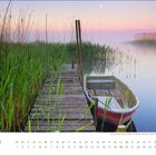 Kalender für September mit einem Steg und Boot in einer ruhigen, nebligen Landschaft bei Sonnenuntergang mit Schilf.