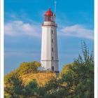 September 2027 Kalenderblatt mit Leuchtturm, blauer Himmel, Bäume im Vordergrund.