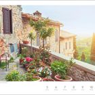 Text: "Terrasse in San Gimignano in der Toskana, Italien", "Juli", "27. Woche", "5 Montag", "6 Dienstag", "7 Mittwoch", "8 Donnerstag", "9 Freitag", "10 Samstag", "11 Sonntag". Steinziegelhaus mit Blumentöpfen auf Terrasse, Ausblick über grüne Landschaft.
