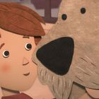 Illustration zeigt ein Kind mit braunem Haar, das liebevoll einen großen Hund ansieht. Beide haben ein Lächeln im Gesicht.