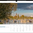 Text: "September. Das Radolfzeller Ufer beim Motor-Yacht-Club – Blick zum Münster Unserer Lieben Frau."  
Szenerie: Boote am Steg, Kirchturm.