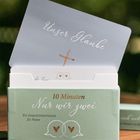 Eine Karte mit "Unser Glaube", darunter ein Kreuz. Schachtel mit "10 Minuten Nur wir zwei" und einem Kartenset für Paare.