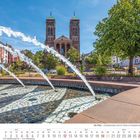 Kalenderseite mit Monat September 2027. Wasserfontänen vor einer Kirche, sonniger Tag, grüne Bäume im Hintergrund.