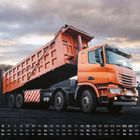Kalenderblatt für Dezember mit einem orangefarbenen Kipper-Lkw auf einer Kohlenhalde im Hintergrund.