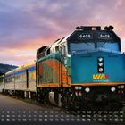 Zahlen unten: Kalender zeigt Monatstage. Zug mit der Beschriftung "VIA Rail Canada" bei Sonnenuntergang.