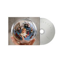 Text: INSTINCT. Eine Frau hält eine Glaskugel; darin ein Zimmer mit Musikinstrumenten. CD rechts daneben.