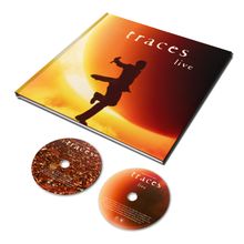 „Traces live“ auf einem Albumcover. Ein Mensch in Bewegung vor einer großen Sonne, dazu zwei CDs unten.